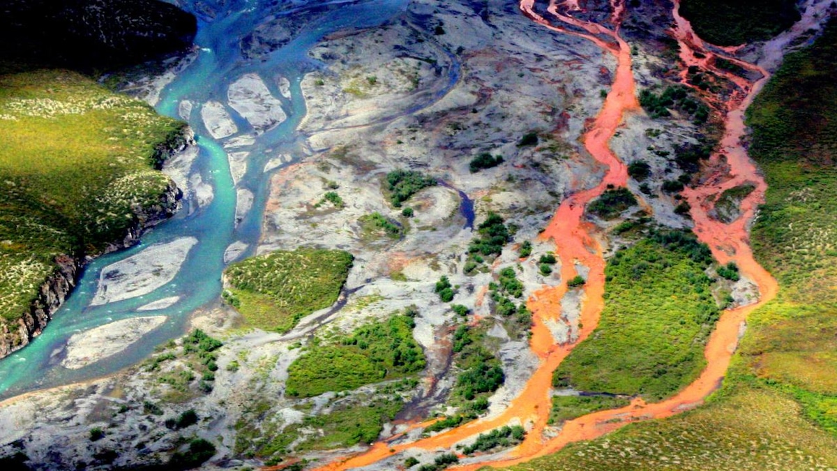 An aerial view of the rust-colored Kutuk River in Gates of the Arctic National Park in Alaska. Thawing permafrost is exposing minerals to weathering, increasing the acidity of the water, which releases metals like iron, zinc and copper.