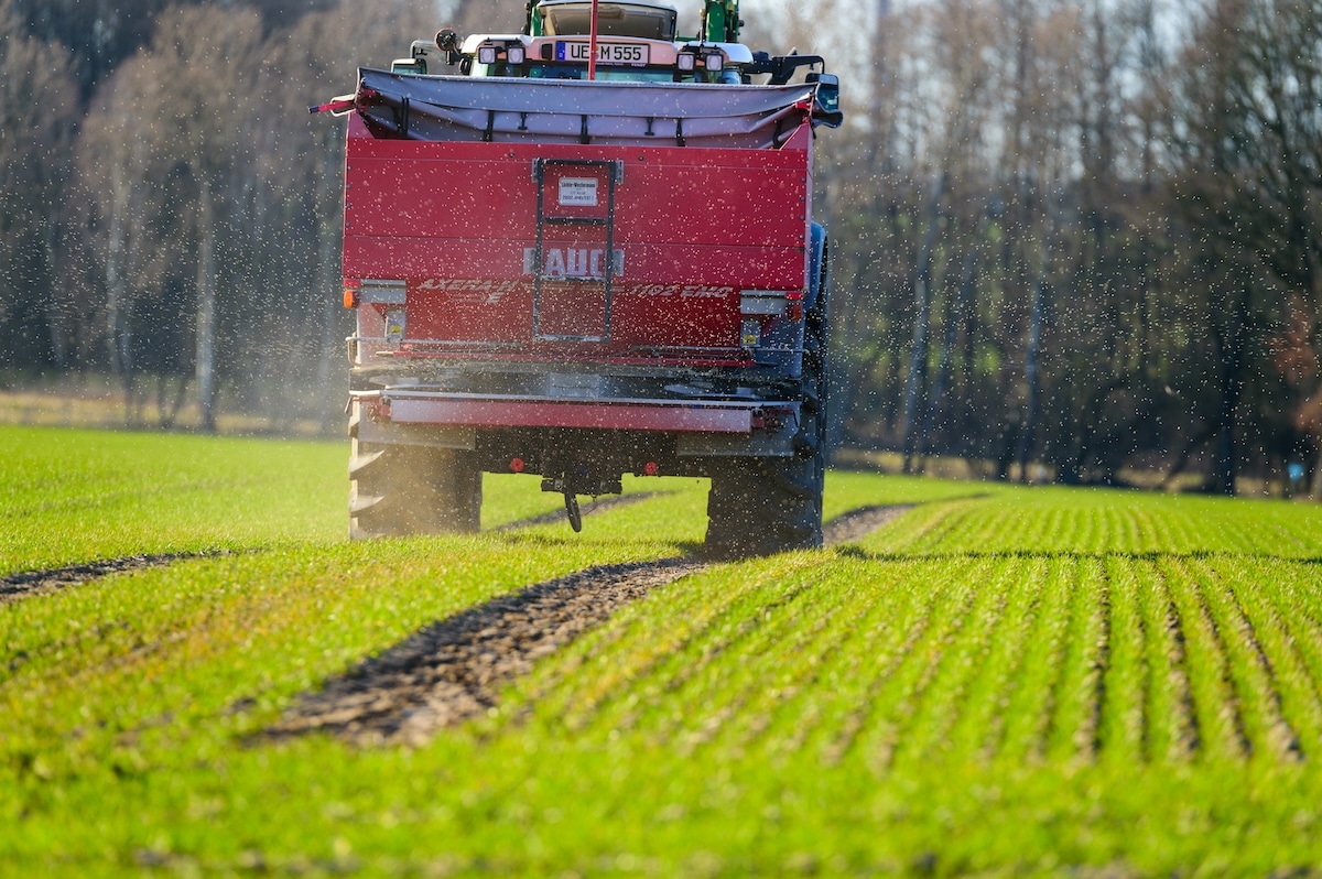 A farmer applies nitrogen fertilizer to a field