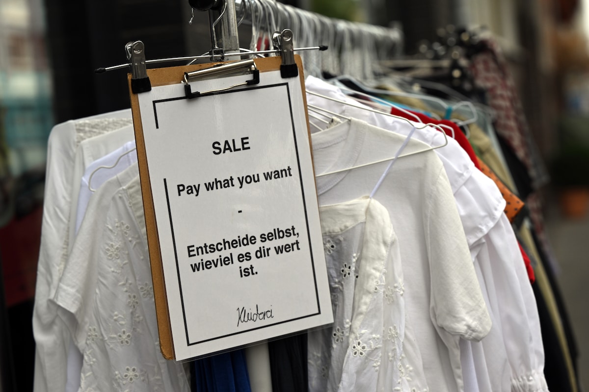 Clothes hang in the Kleiderei second-hand and upcycled clothing store in Cologne, Germany